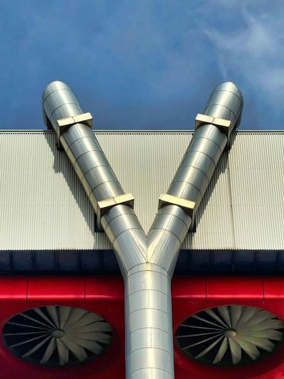 A building with a y shaped pipe and two fans on the side
