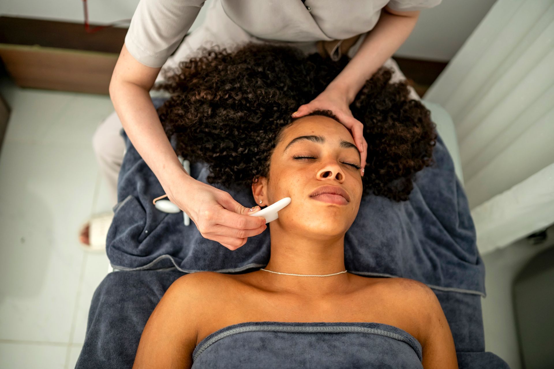 A woman is getting a facial treatment at a spa.