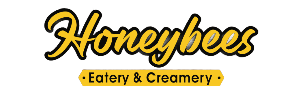 Logo for Honeybees Eatery & Creamery. Yellow script text with black outline, a yellow banner below reads 