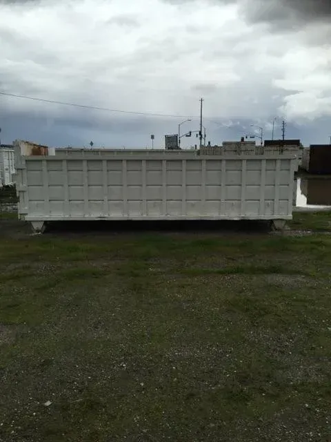 Large, rectangular, white concrete structure on grass
