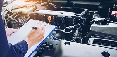 Mechanic Man Checking Car Engine — Auto Maintenance in Denver, CO