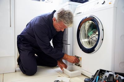 Repairman Fixing The Dryer — Dyer, IN — Anderson Appliance Repair