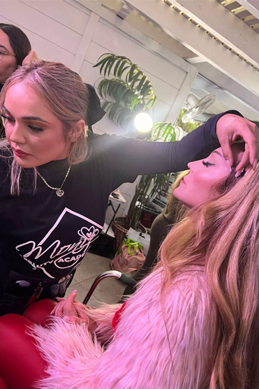 Two women are getting their hair done in a salon.