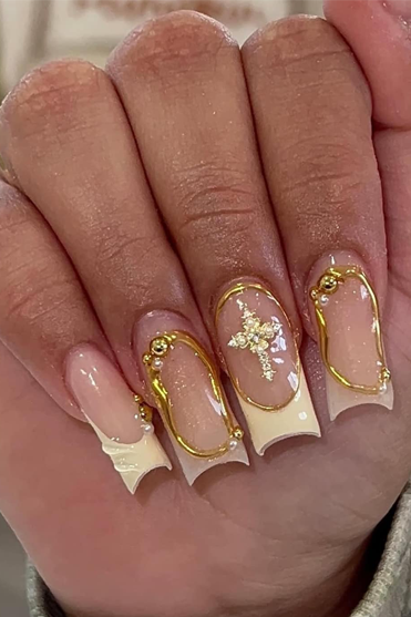 A close up of a person 's nails with a cross on them.