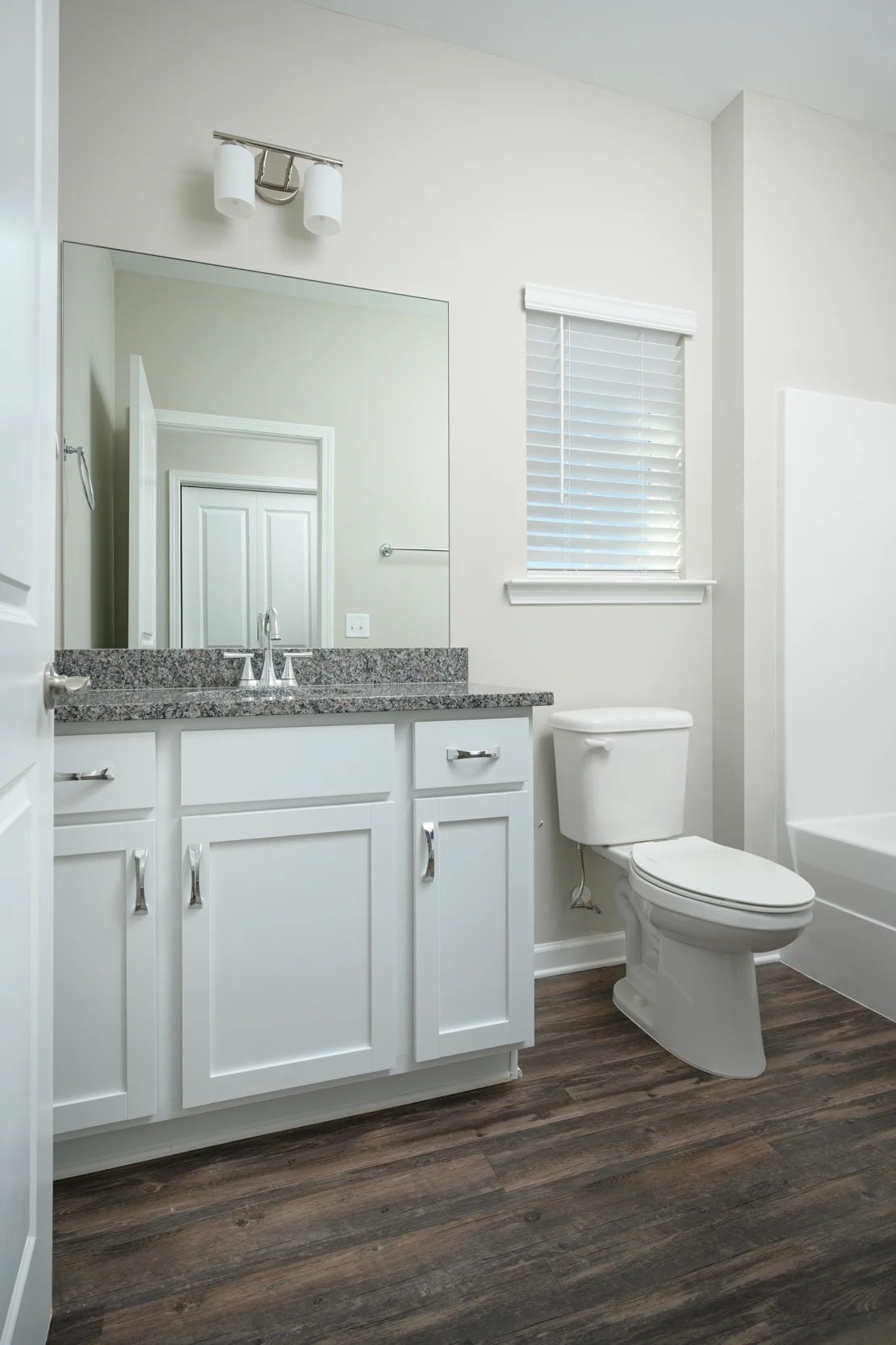 A bathroom with two sinks and a large mirror.