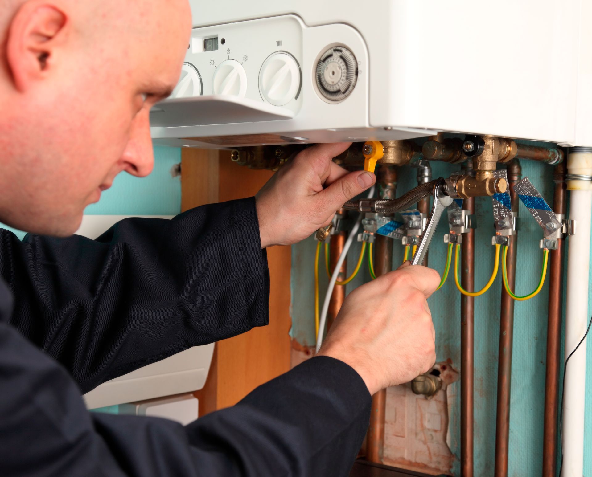 Plumber repairing a residential water heater, providing expert water heater repair services.