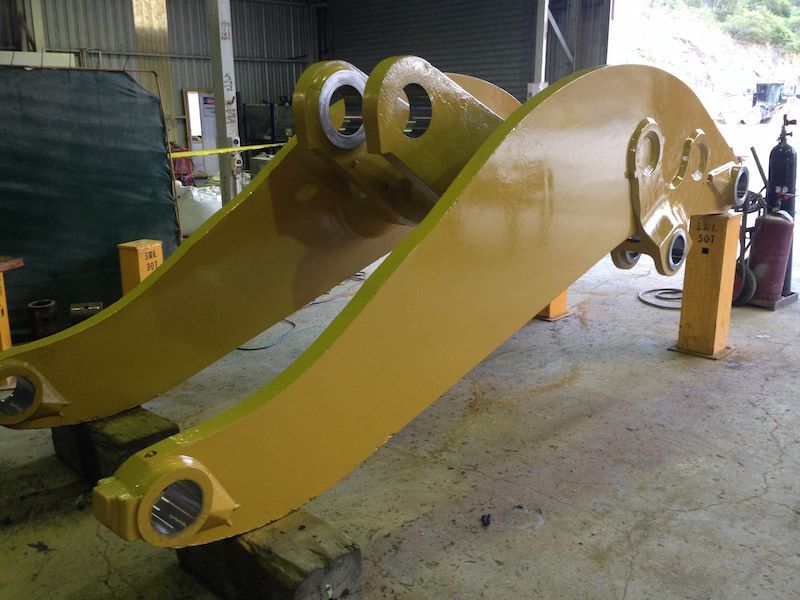 A yellow object is sitting on a concrete floor in a warehouse — Line Boring in Chevallum, QLD