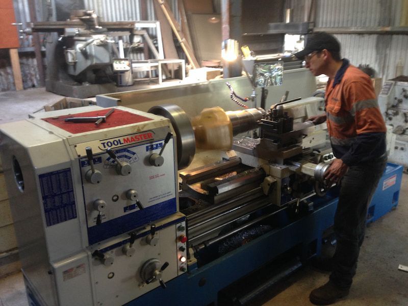 A man is standing next to a lathe in a factory — Line Boring in Chevallum, QLD