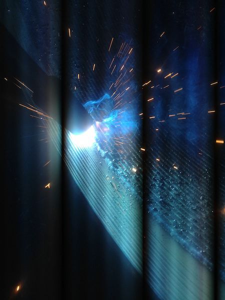 A person is welding a piece of metal in a dark room — Line Boring in Chevallum, QLD