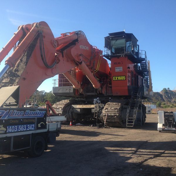 A large excavator is parked next to a tow truck — Line Boring in Chevallum, QLD