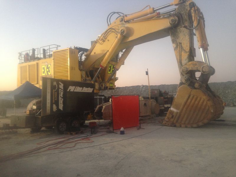 A large excavator is sitting in a parking lot next to a truck — Line Boring in Chevallum, QLD