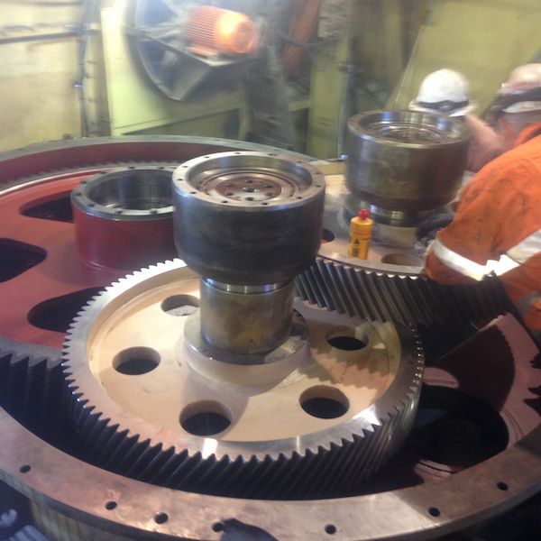 A man is working on a large gear in a factory — Line Boring in Chevallum, QLD