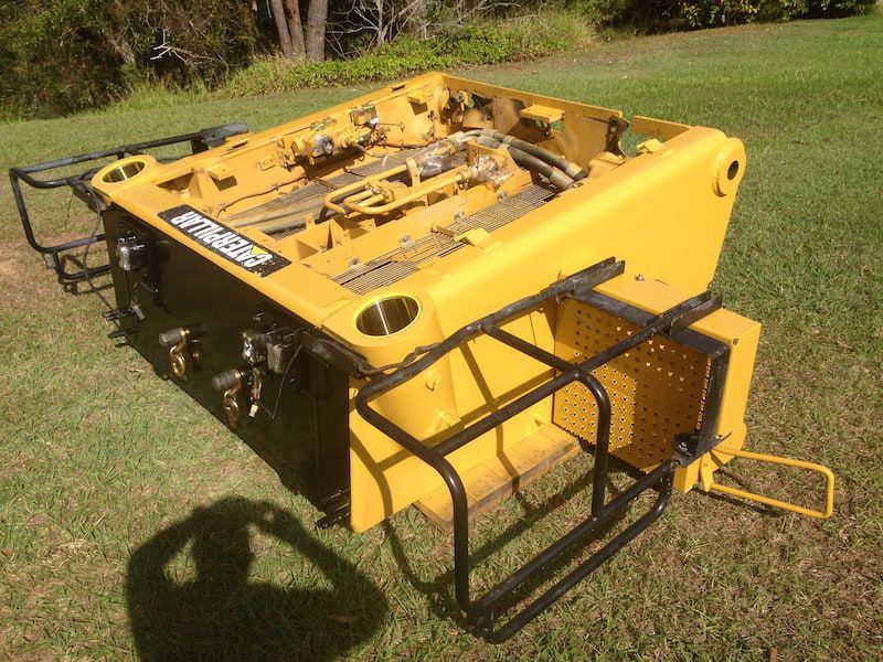 A yellow tractor is sitting in a grassy field — Line Boring in Chevallum, QLD