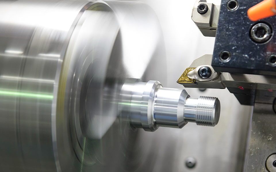 A machine is cutting a piece of metal on a lathe — Line Boring in Chevallum, QLD