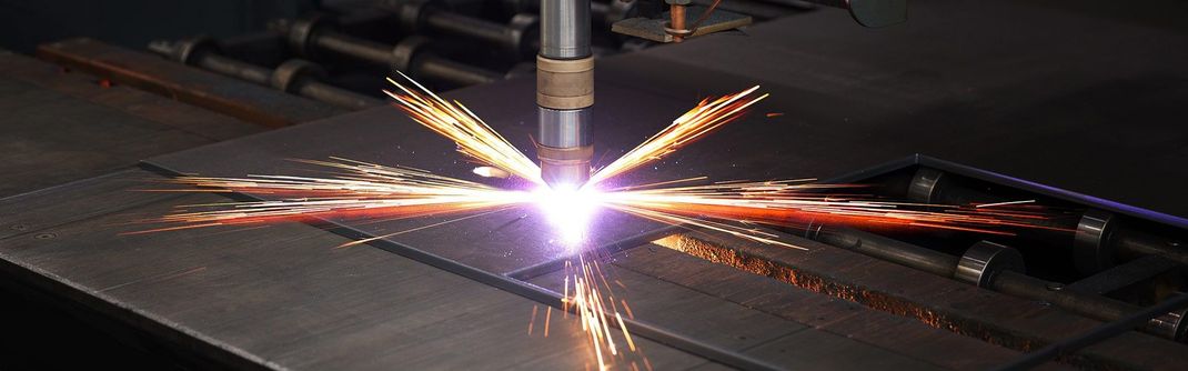 A machine is cutting a piece of metal with sparks coming out of it — Line Boring in Chevallum, QLD