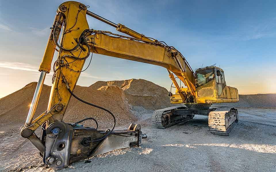 A yellow excavator is sitting on top of a pile of dirt — Line Boring in Chevallum, QLD