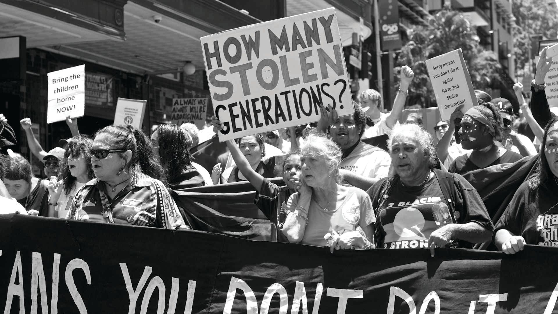 a group of people are holding signs that say how many stolen generations