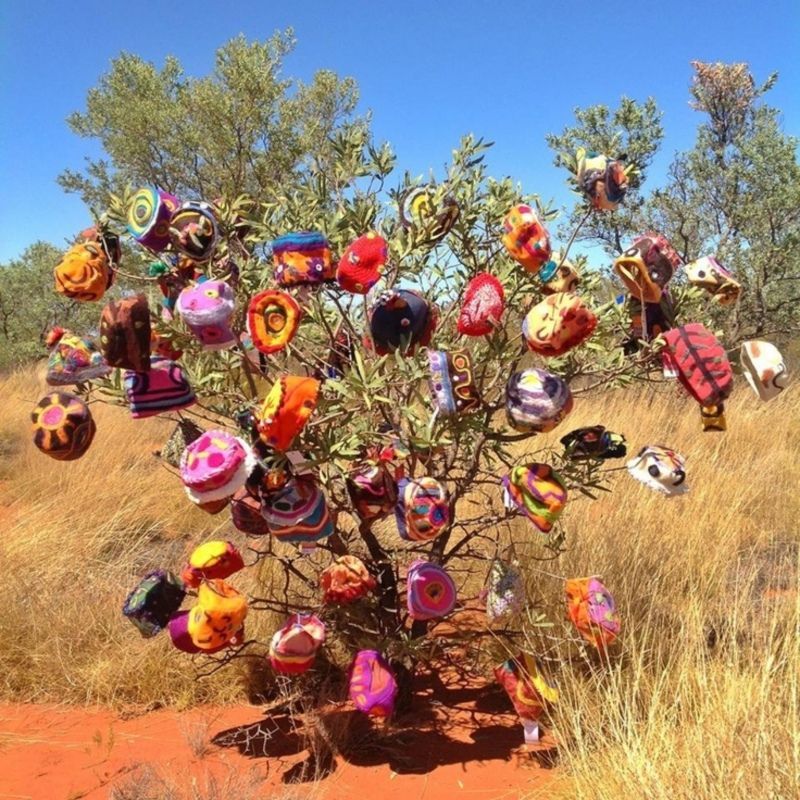 a tree with lots of balloons hanging from it
