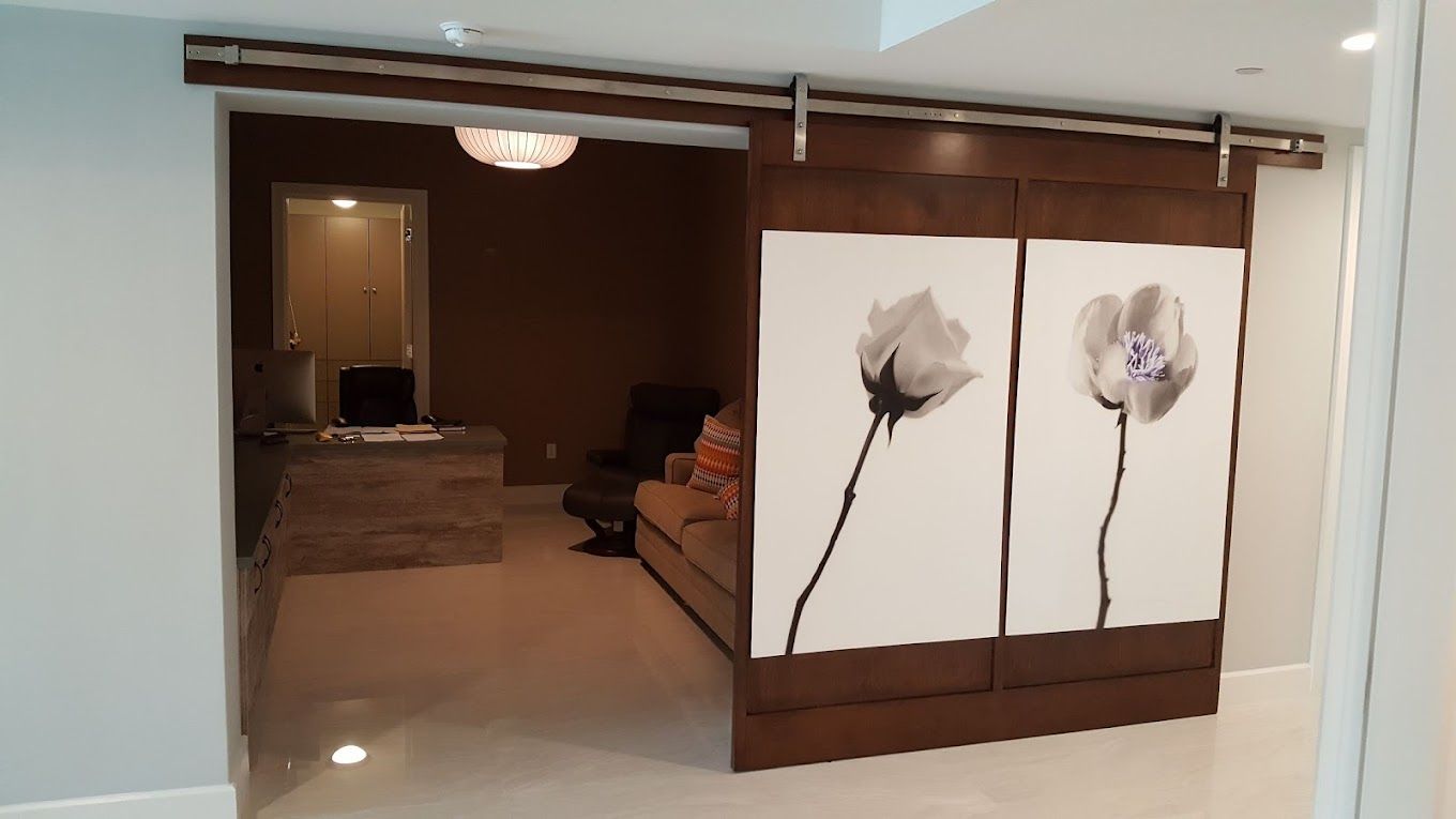 A living room with a sliding barn door with flowers on it