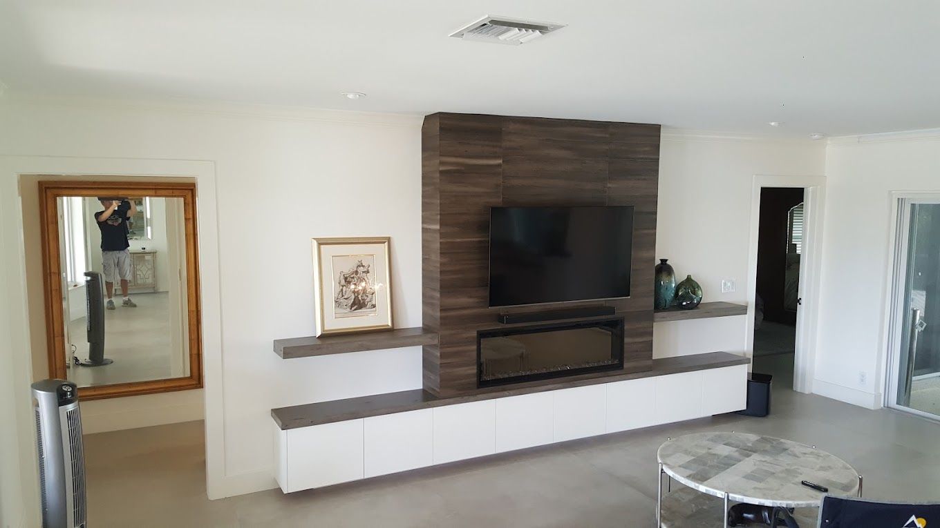 A living room with a fireplace and a flat screen tv