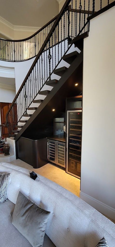 A hallway with black doors and a wooden floor