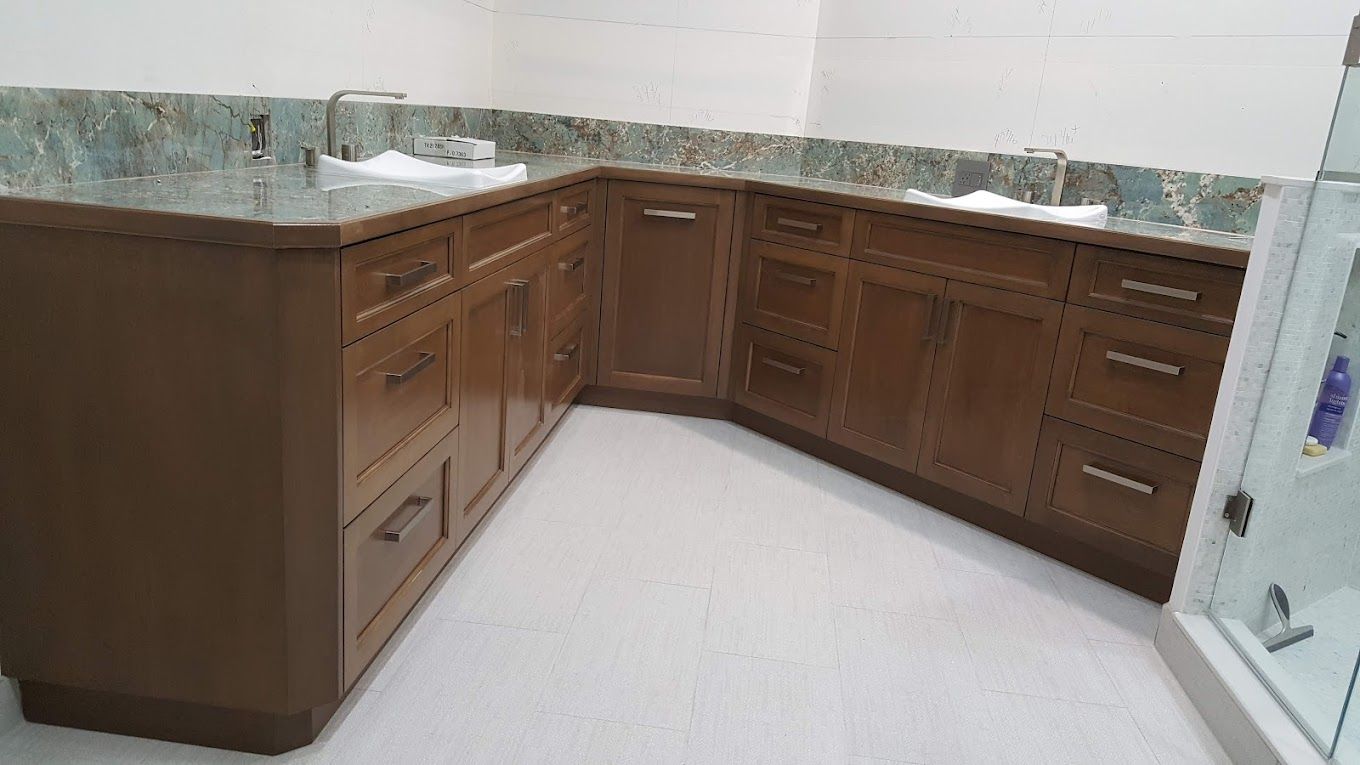 A bathroom with two sinks and wooden cabinets.