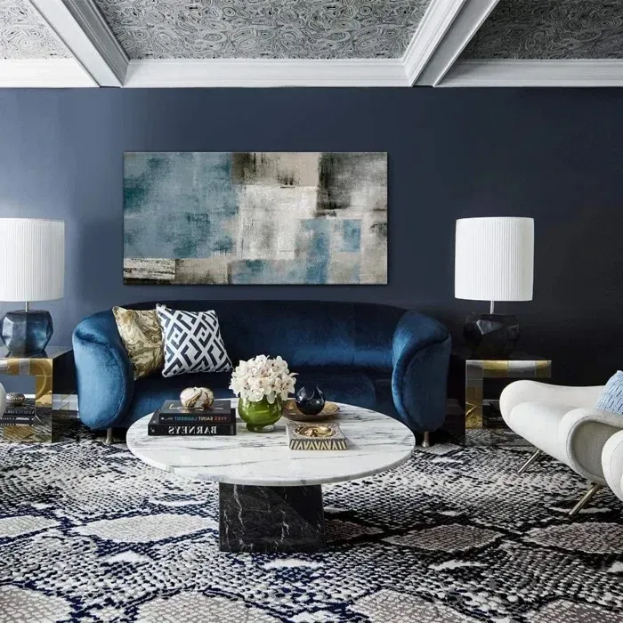A living room with a blue couch and a white coffee table