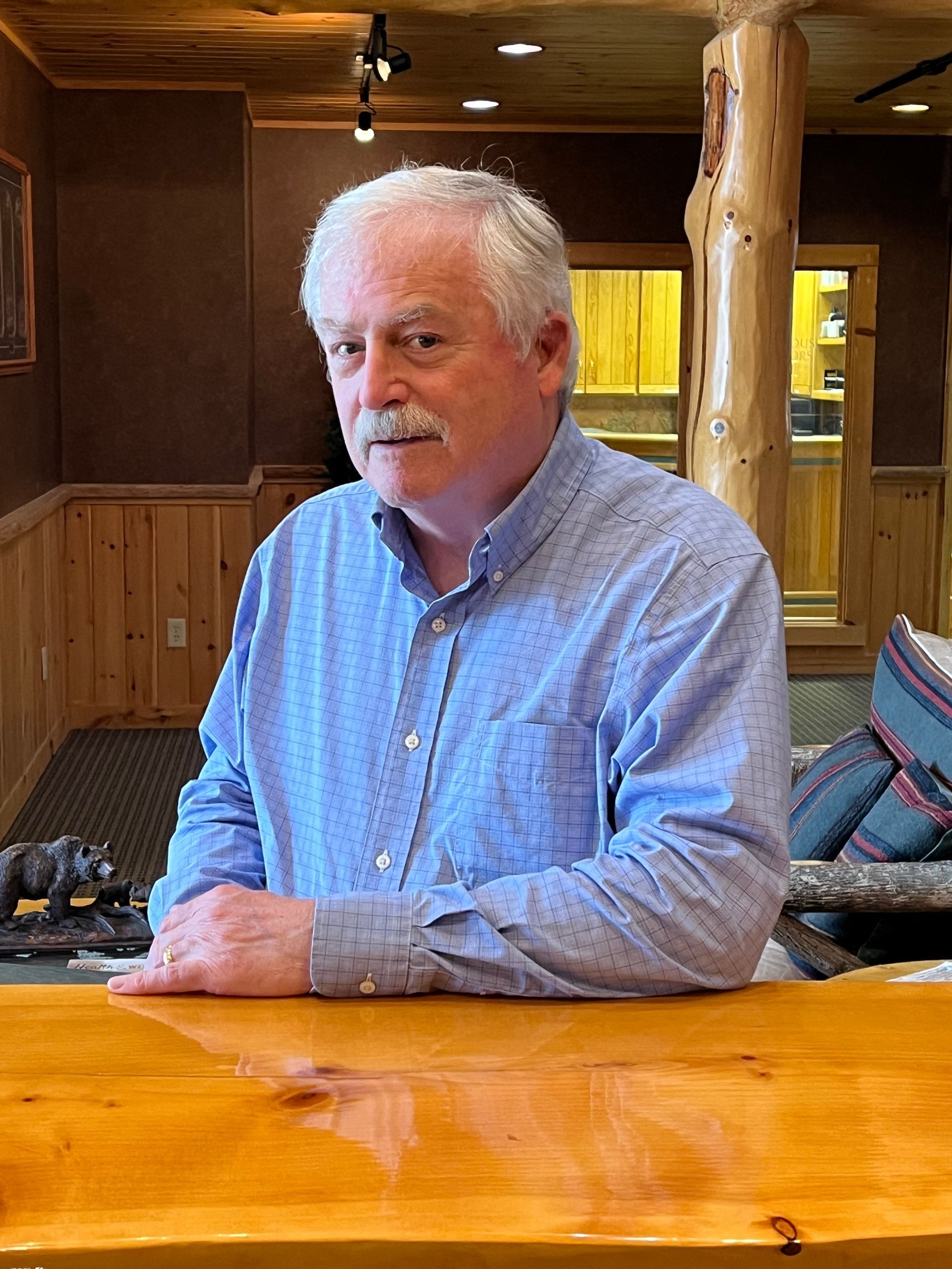 A woman is holding a hearing aid in her hand.