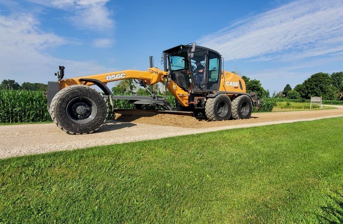 A yellow bulldozer is parked in a muddy field