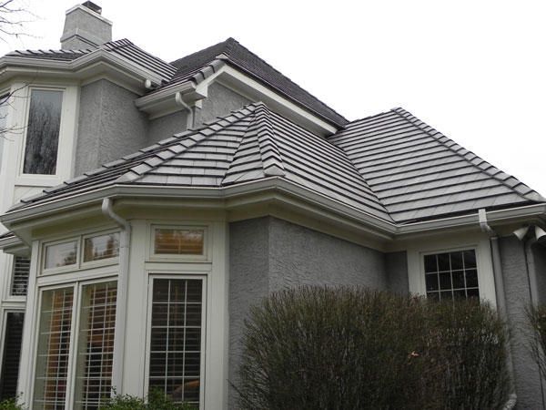 A Large House with A Gray Roof and White Windows — Kansas City, KS — All American Roofing