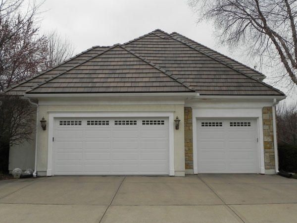 A Large House with Two White Garage Doors — Kansas City, KS — All American Roofing