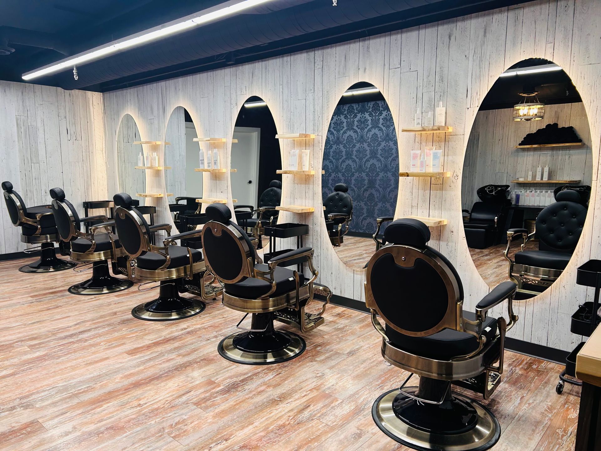 A barber shop with a lot of chairs and mirrors.