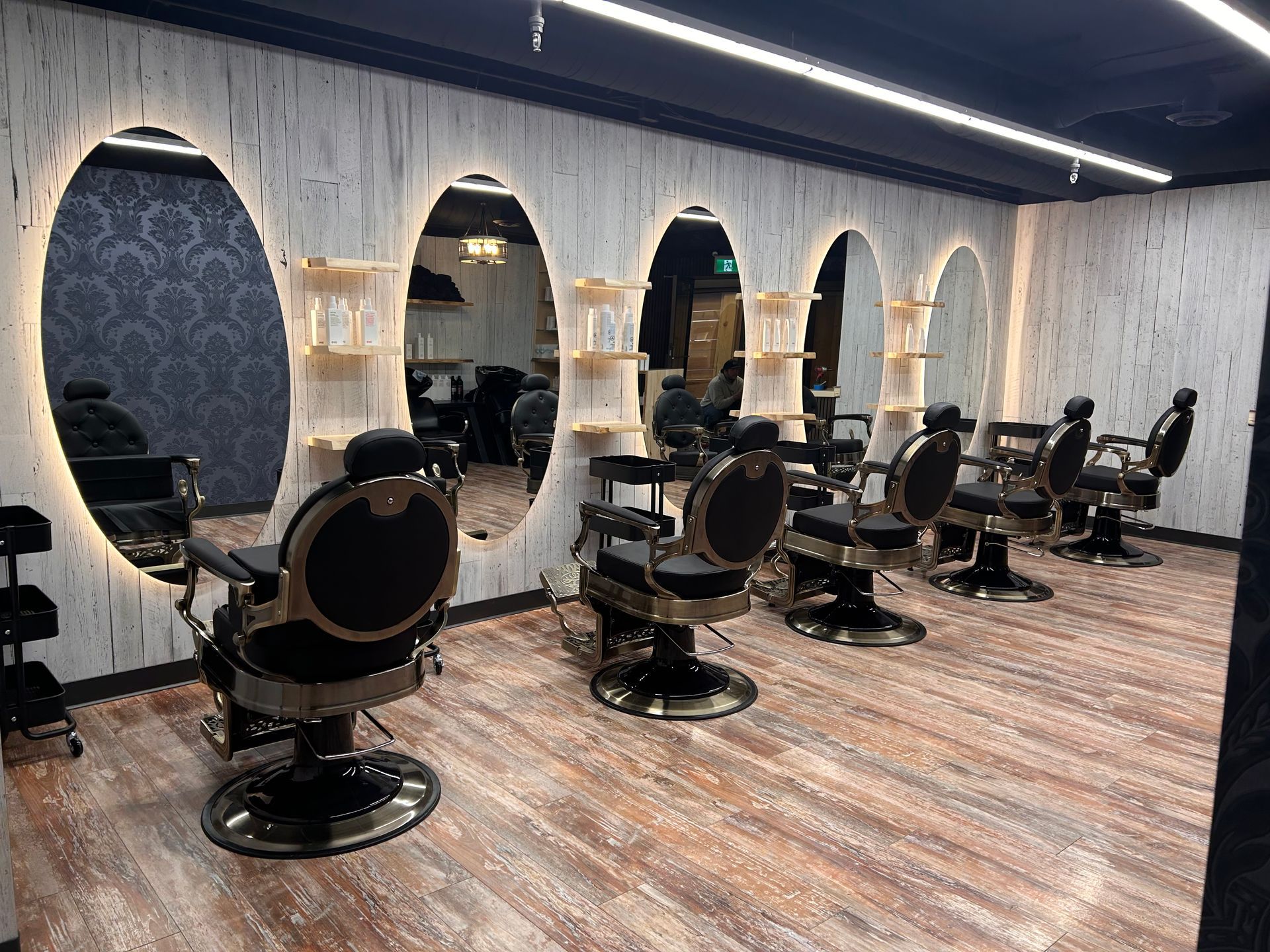 A barber shop with a lot of chairs and mirrors.