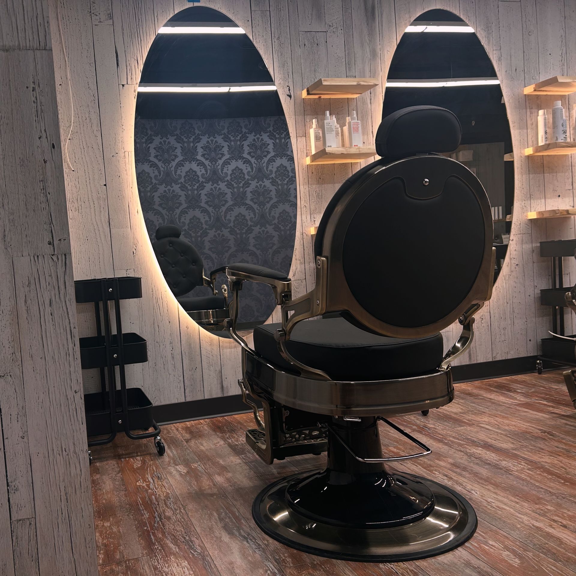 A barber chair in a room with two mirrors