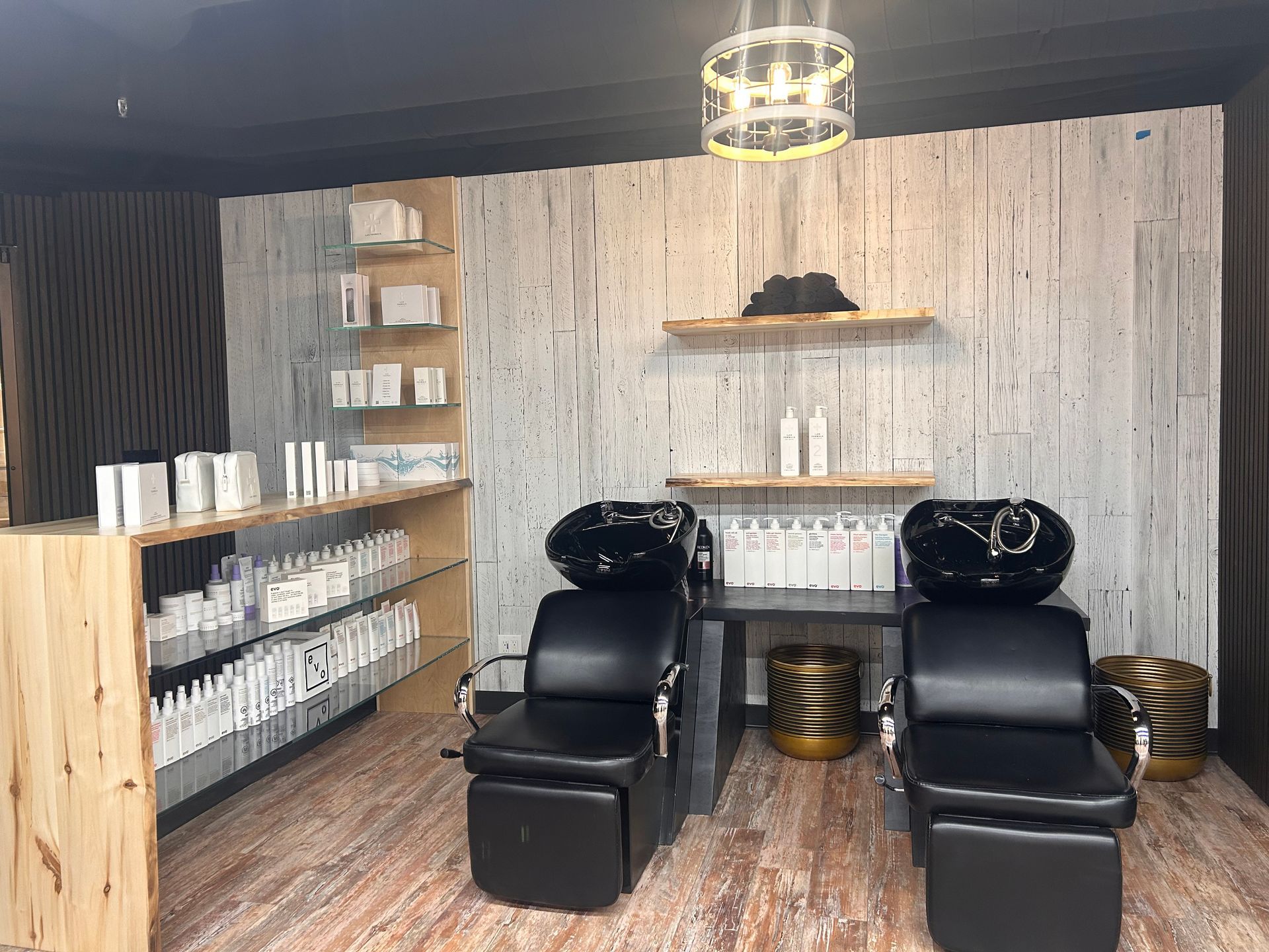 A hair salon with two chairs and a sink.