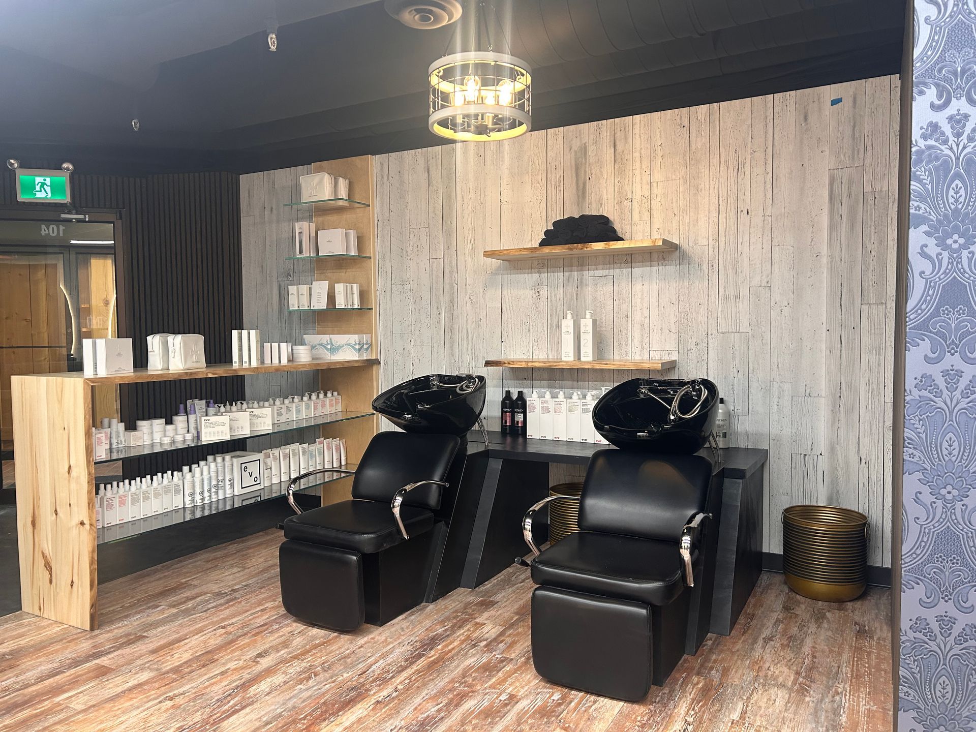 A hair salon with two chairs and two sinks.