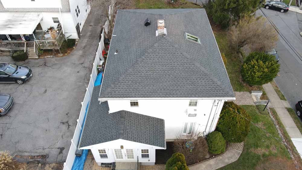 An aerial view of a house with a roof that is being repaired.