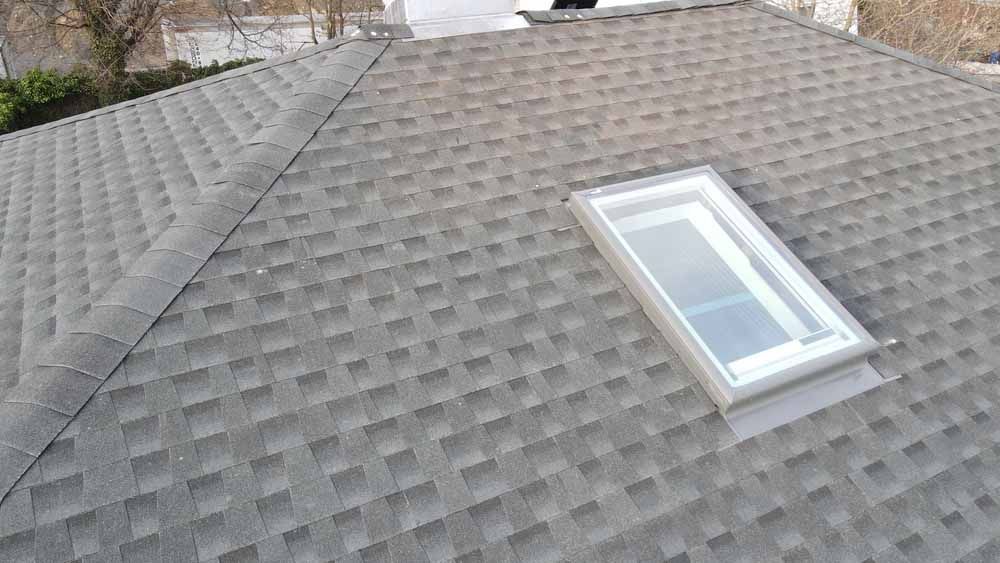 A roof with a skylight on top of it.