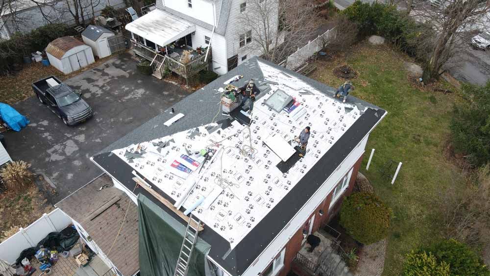 An aerial view of a roof being installed on a house.