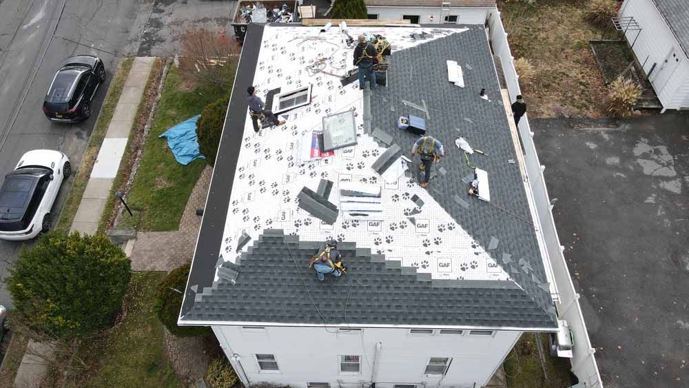 An aerial view of a roof being installed on a house.