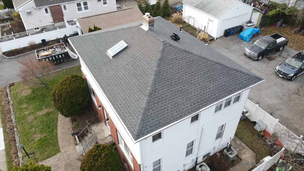 An aerial view of a house with a gray roof.