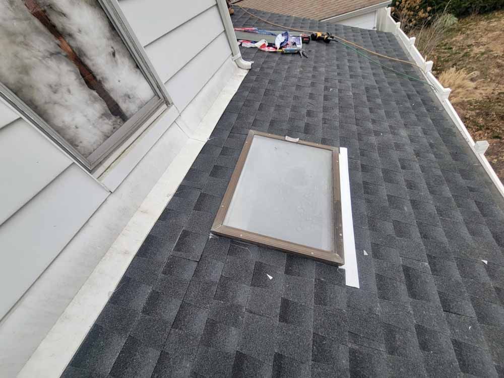 A skylight is being installed on the roof of a house.