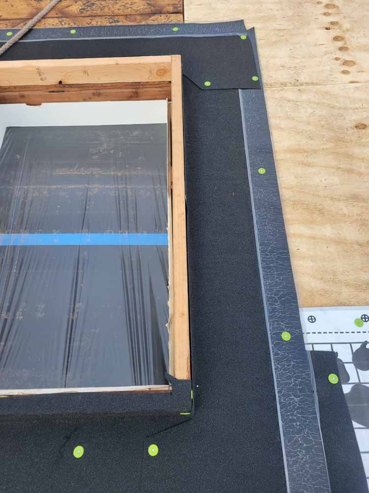 A picture of a window being installed on a roof