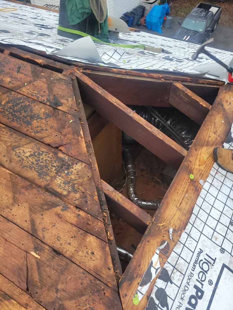 A person is working on the roof of a house.