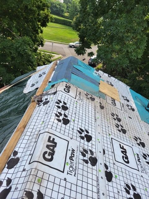 A roof with a tiger paw roofing material on it