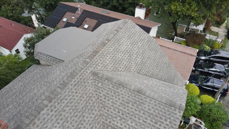 An aerial view of a roof of a house in a residential area.