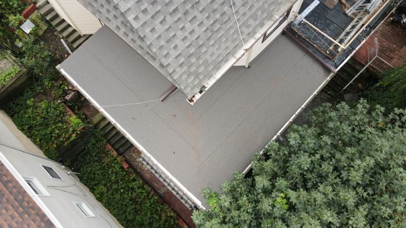 An aerial view of a house with a roof and a garage.