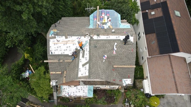 An aerial view of a house with a roof being installed.