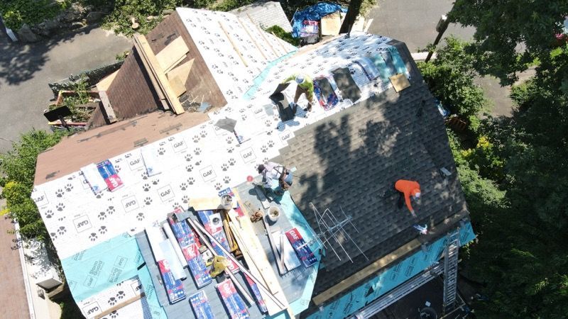 An aerial view of a roof being installed on a house.