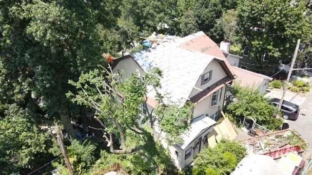 An aerial view of a house surrounded by trees